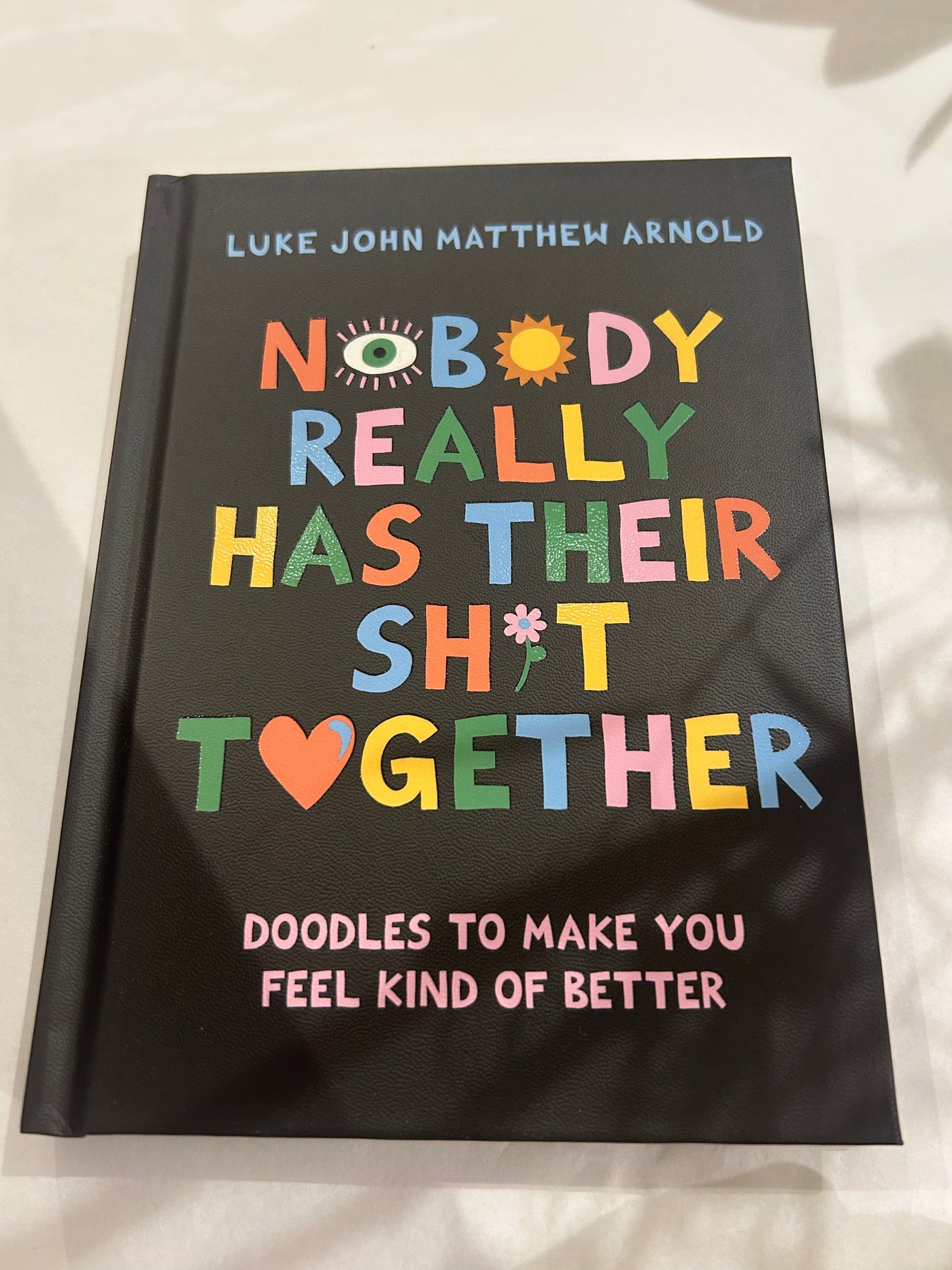 Book titled 'Nobody Really Has Their Sh*t Together' by Luke John Matthew Arnold on a light background