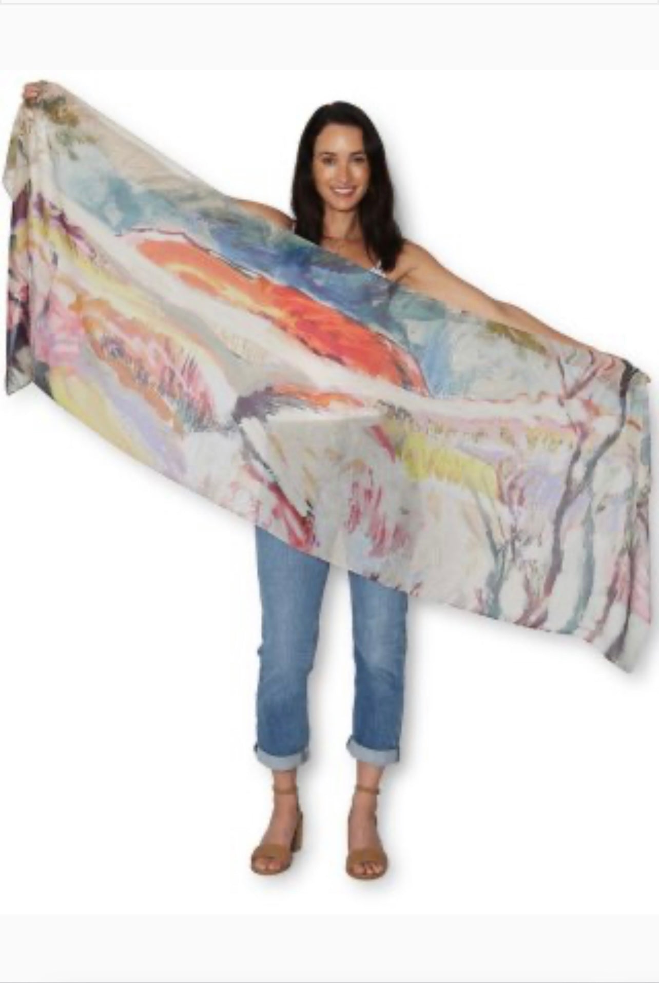 Woman holding a large, colorful scarf with a white background