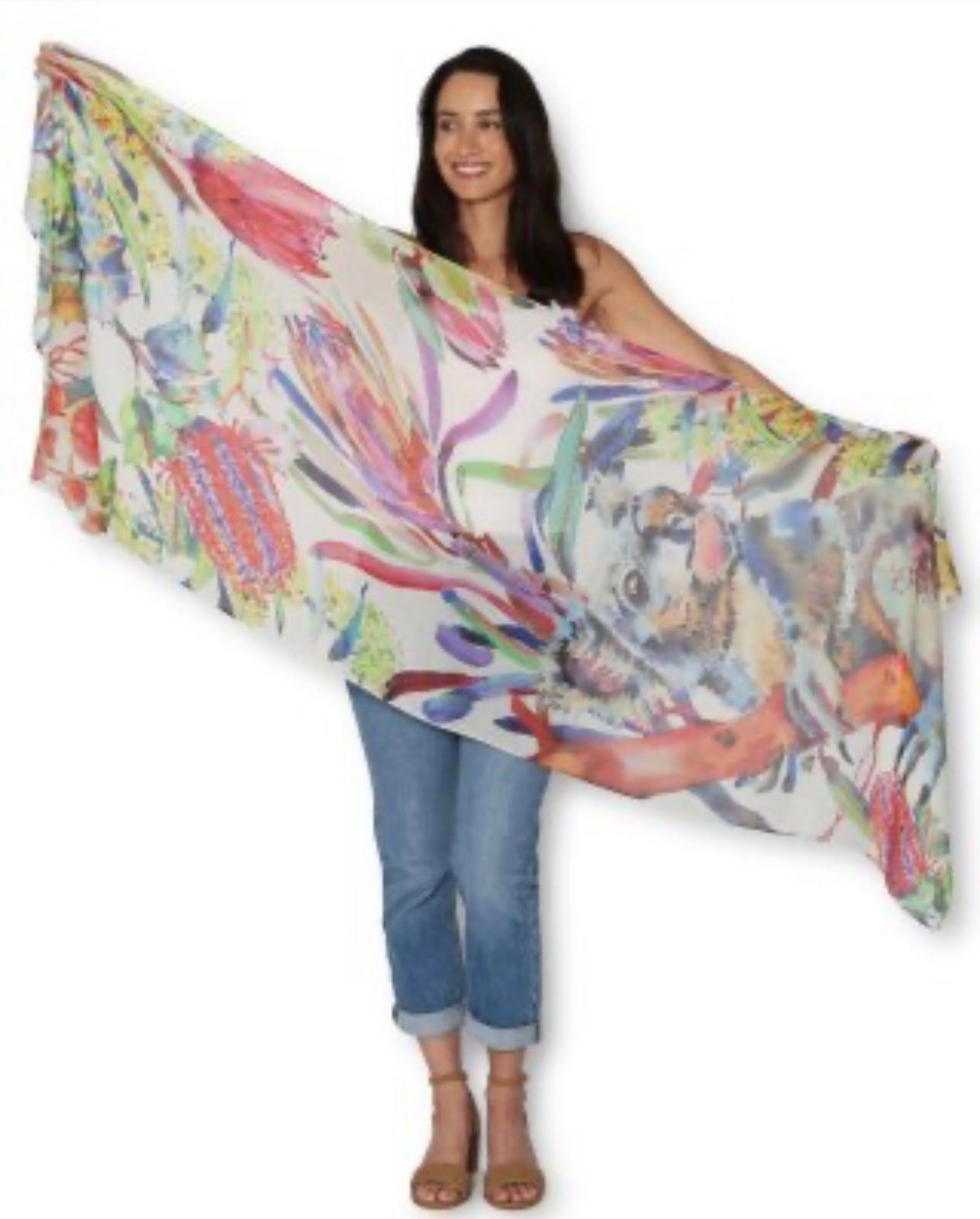 Woman holding a colorful scarf with a floral design on a white background