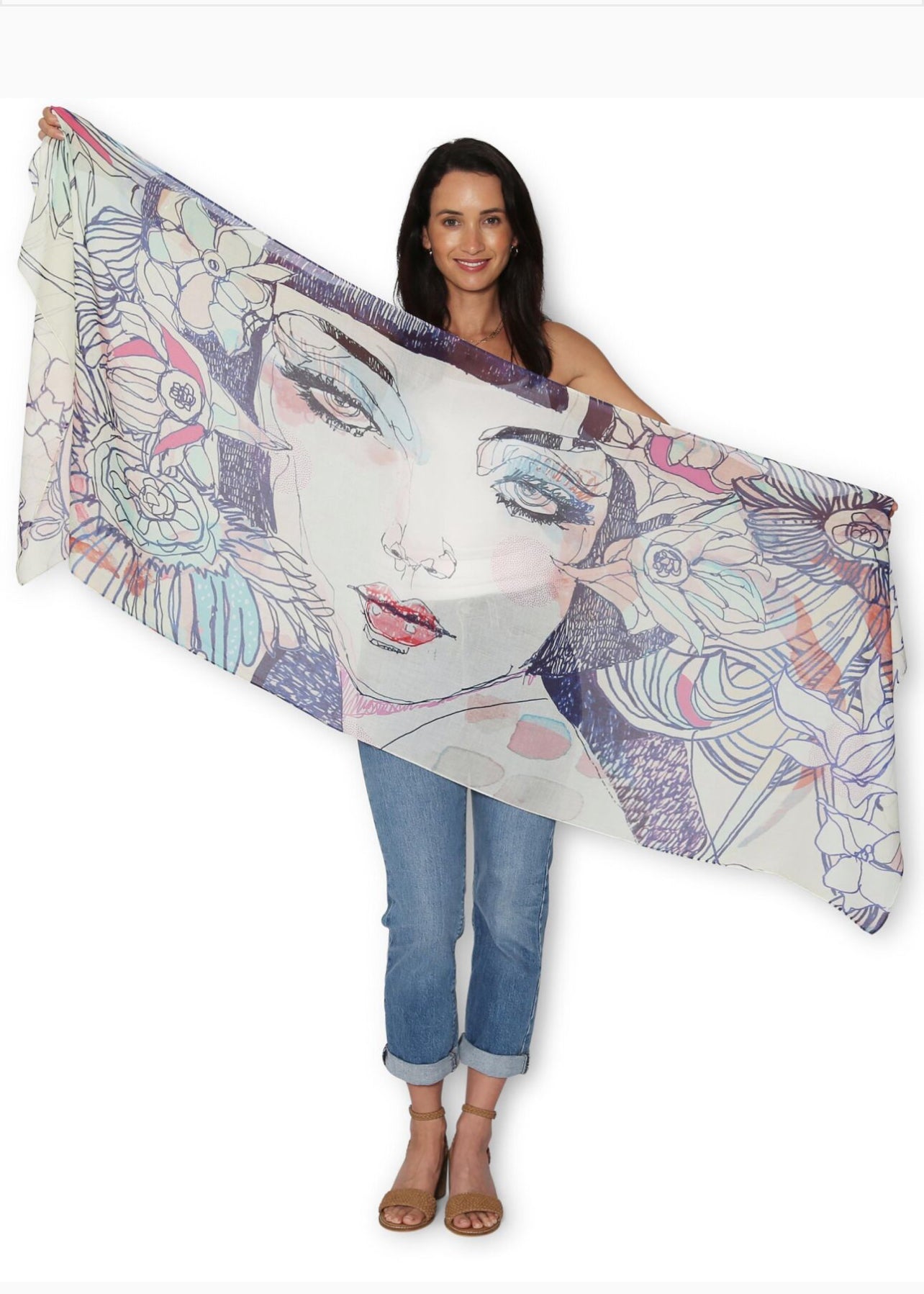Woman holding a colorful scarf with artistic design on a white background