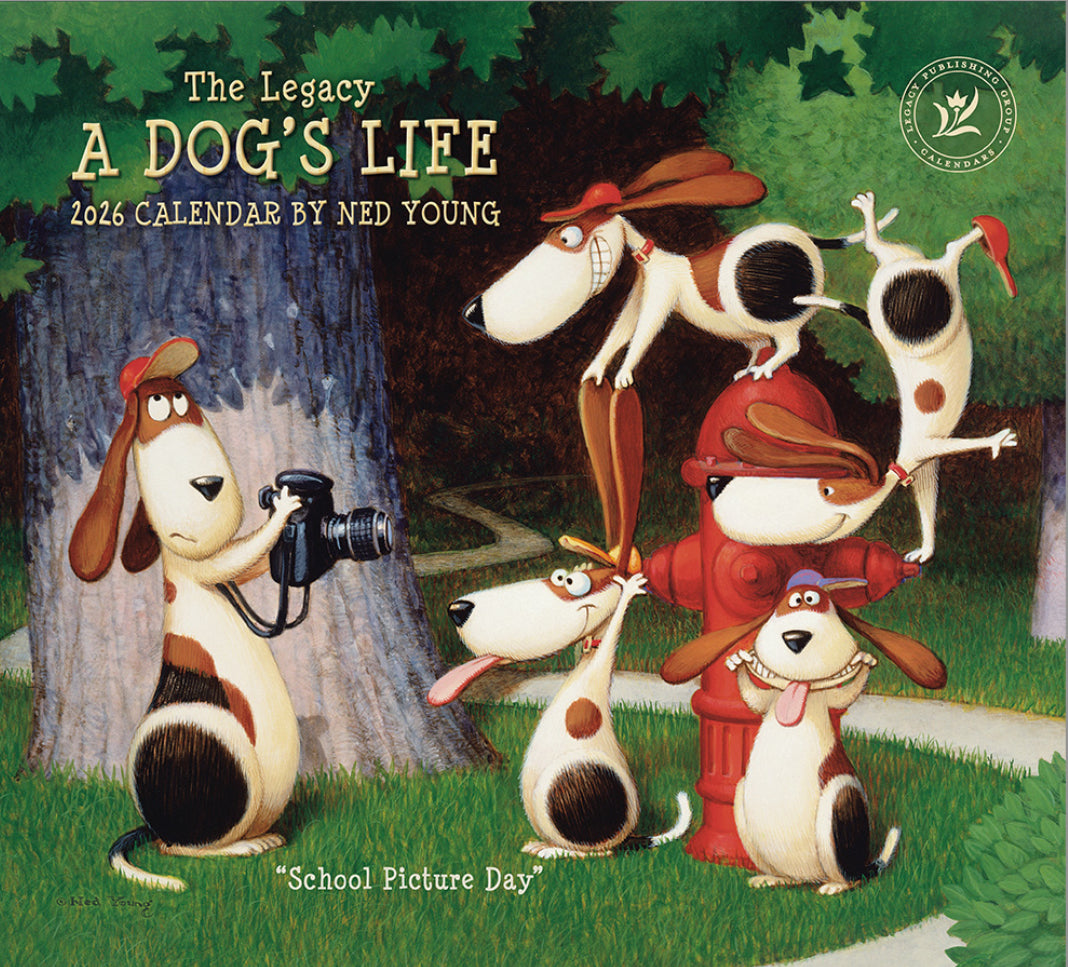 Calendar cover featuring cartoon dogs in a park with a photographer, titled 'The Legacy A Dog's Life' by Ned Young.
